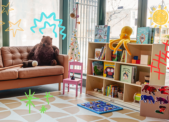 A bookshelf-lined lounge and play area inside WonderPlay & Coffee.