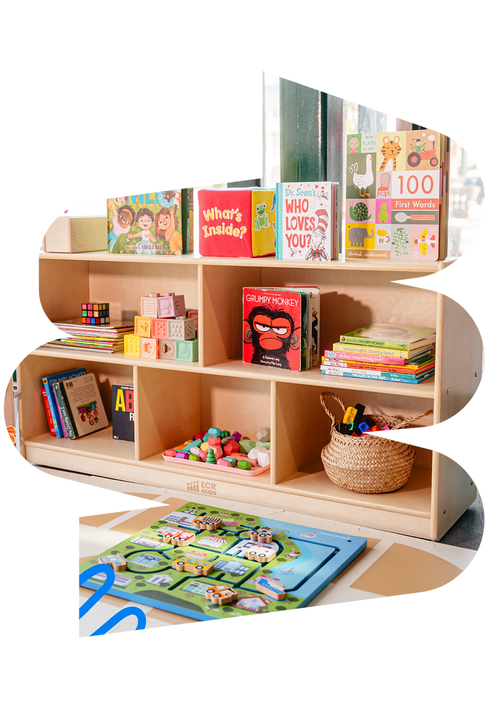 A child-friendly indoor play area with low shelves and imaginative play stations at WonderPlay.