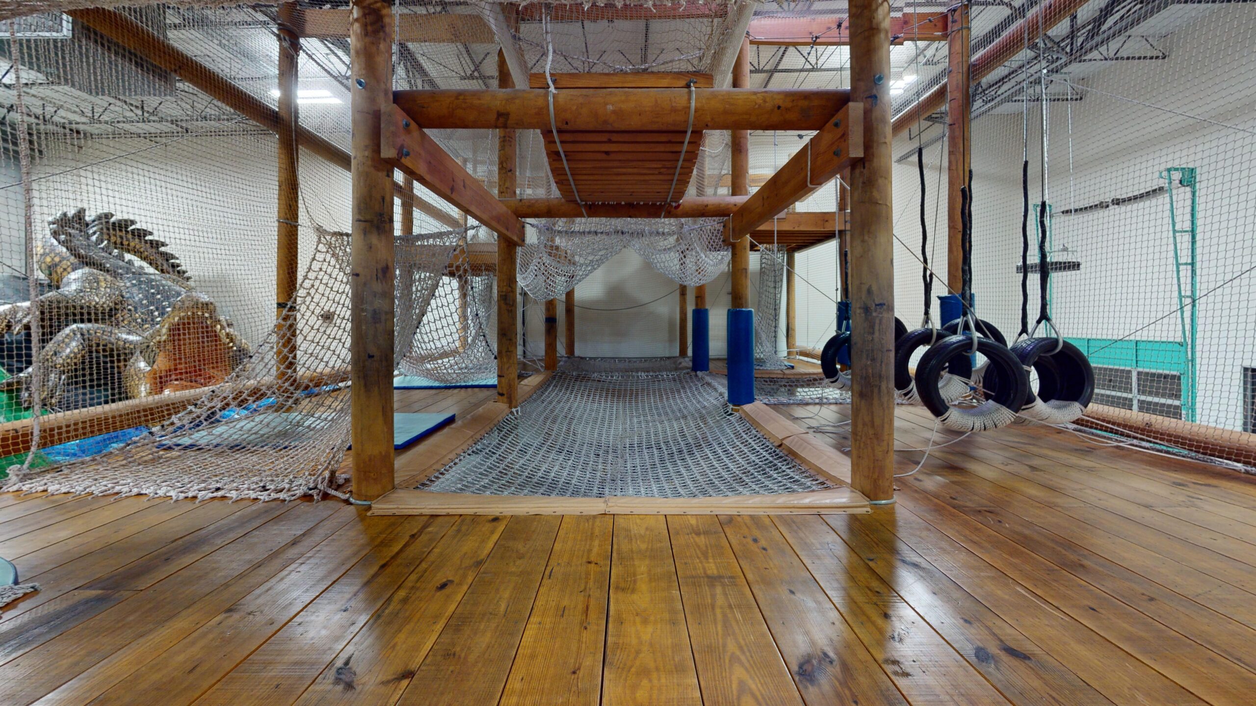 Large netted ropes-course-style play structure at Wonderwild in Houston.