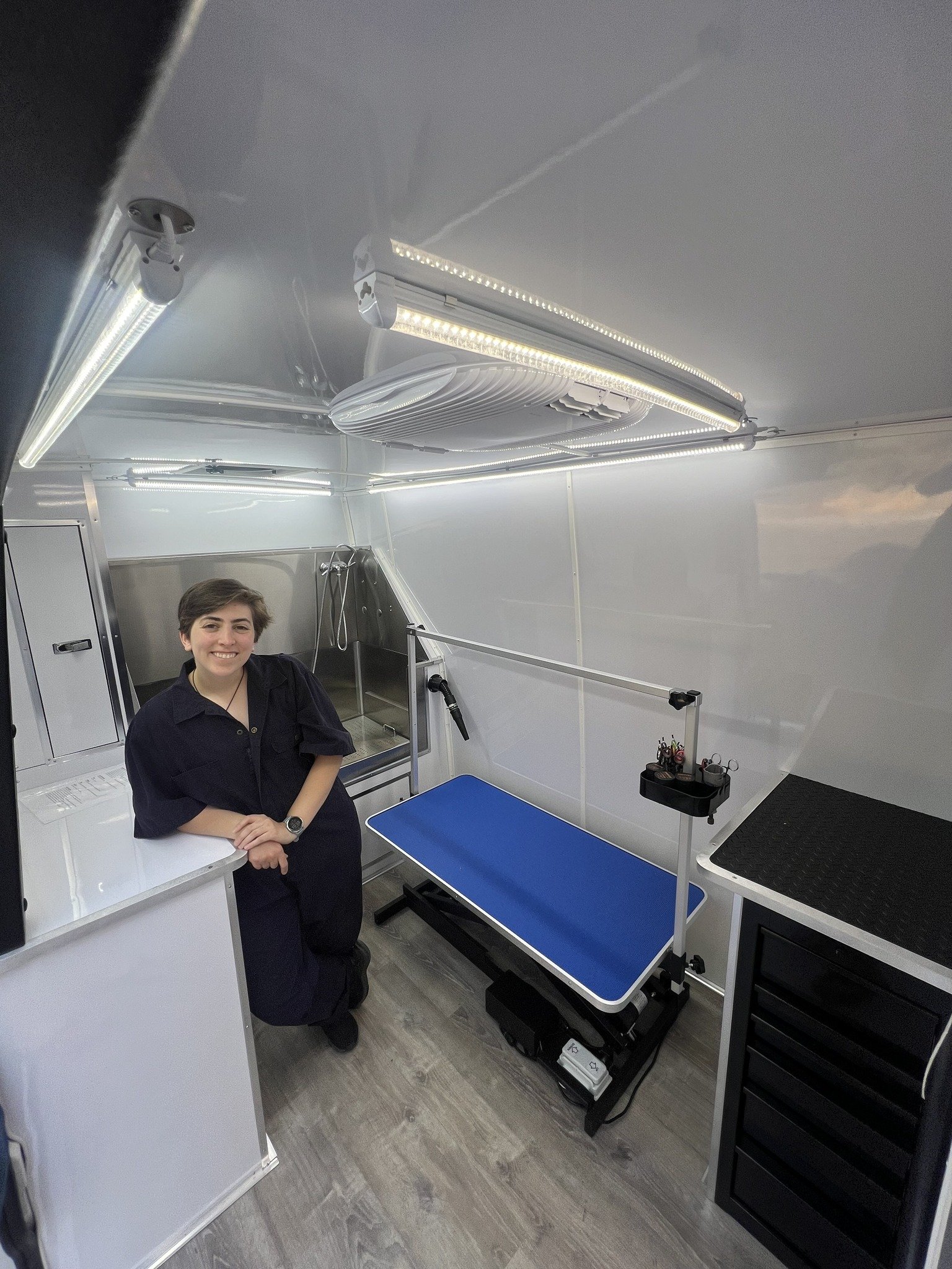 Dirty Critters groomer inside the mobile grooming unit