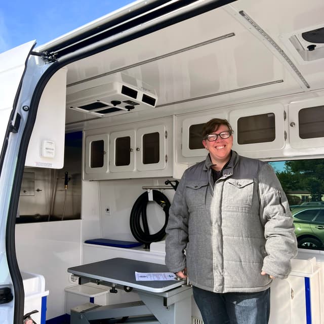 Owner Amy inside the Little Blue Groom Buggy van