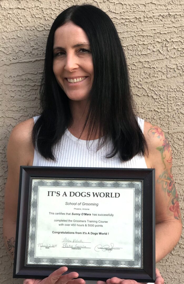 Sunny Days Mobile Grooming owner holding an award