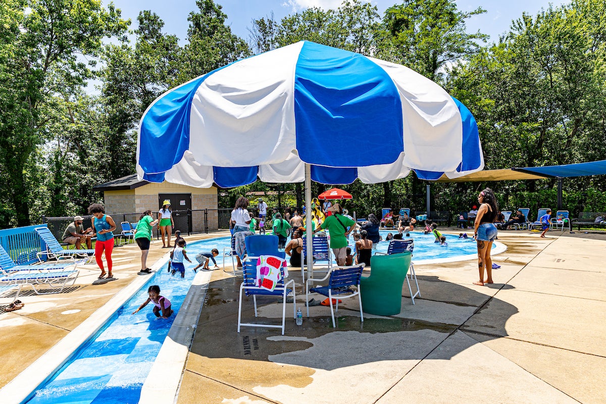 Circular kiddie pool area with entry ramp and shade umbrella at Allentown.