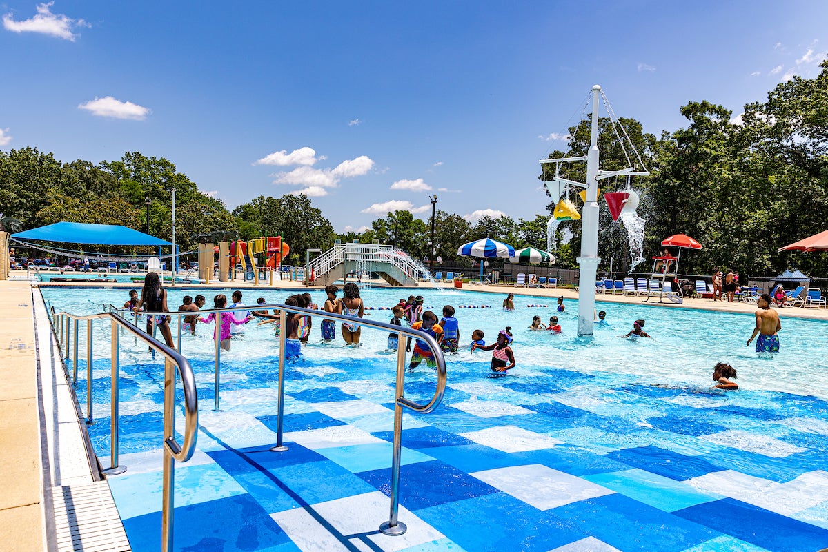 Outdoor pool with central splash feature at Allentown.