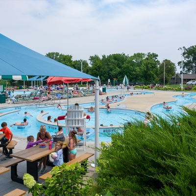 Shaded seating and picnic-style tables at Alligator's Creek Aquatic Center.