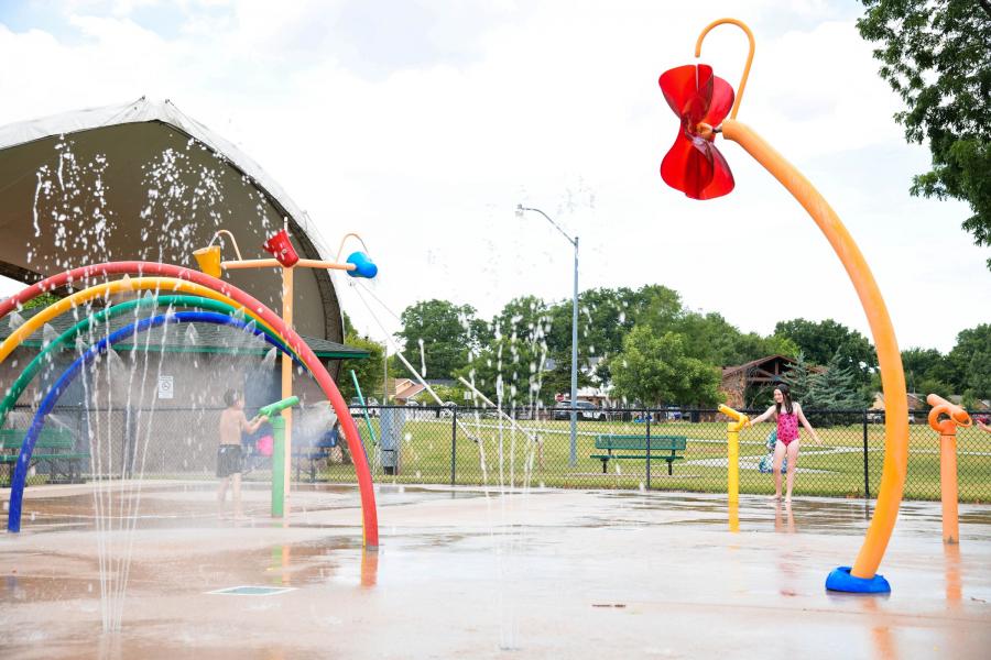 Families using the splash pad at Andrews Park.