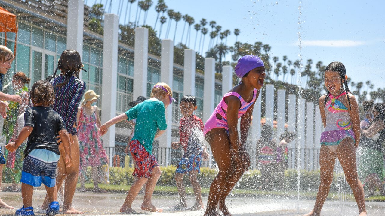 Children playing at the splash pad at the Annenberg Community Beach House.