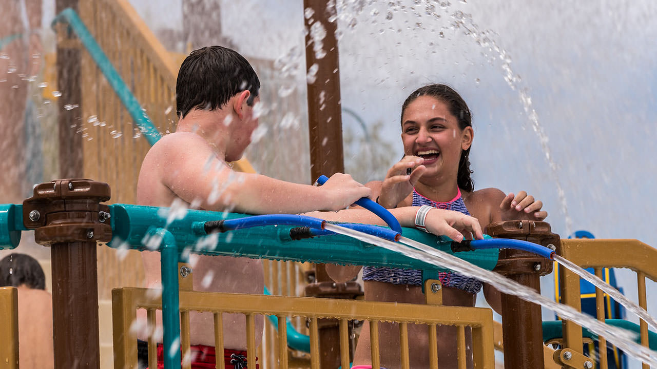Children playing under the water features at Battle of Lake Erie.
