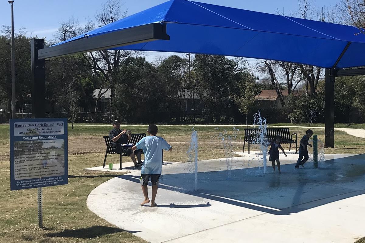 Kids playing in the splash pad at Benavides Park.