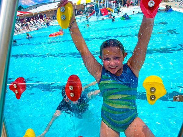 Child enjoying the outdoor water park at Clarksville Aquatic Center.