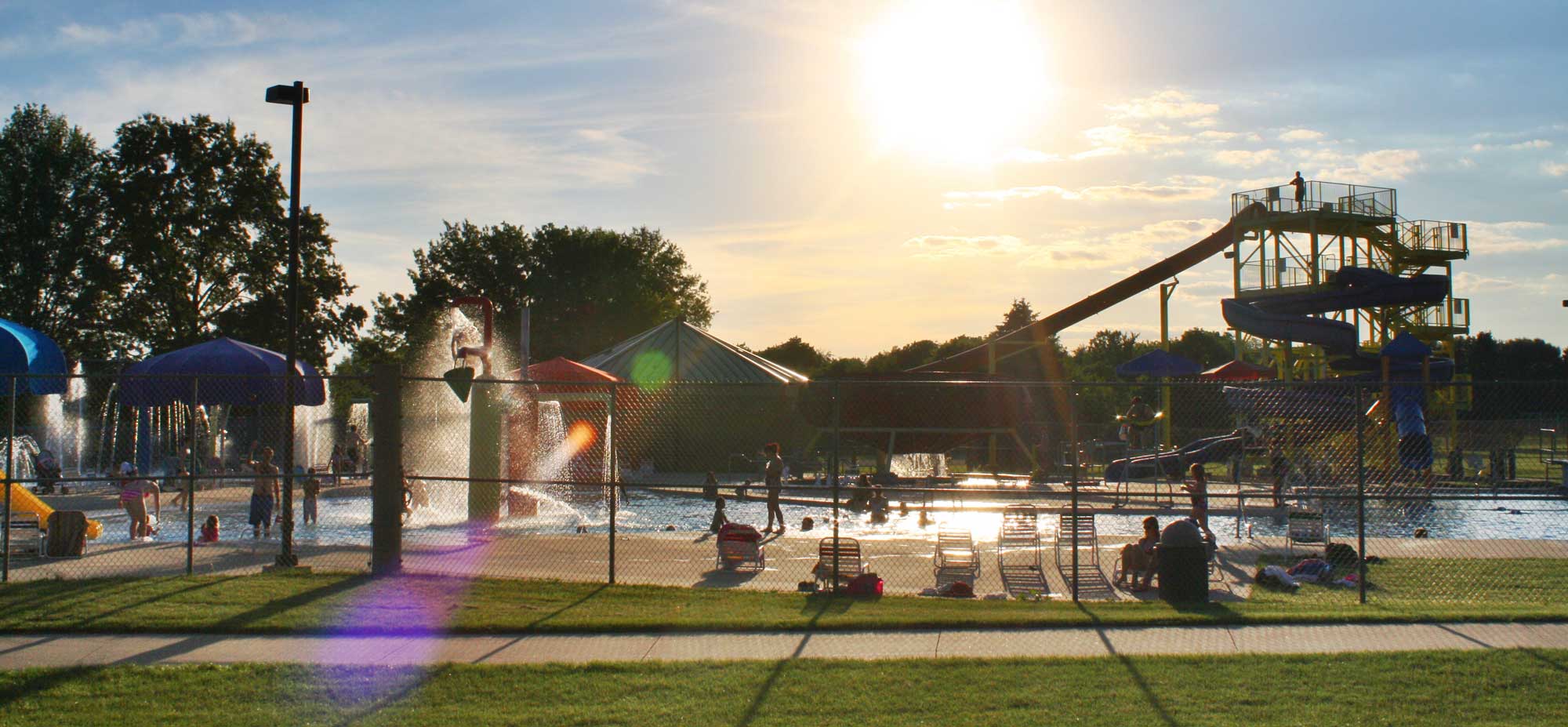 Coralville Community Aquatic Center exterior water view at sunset.