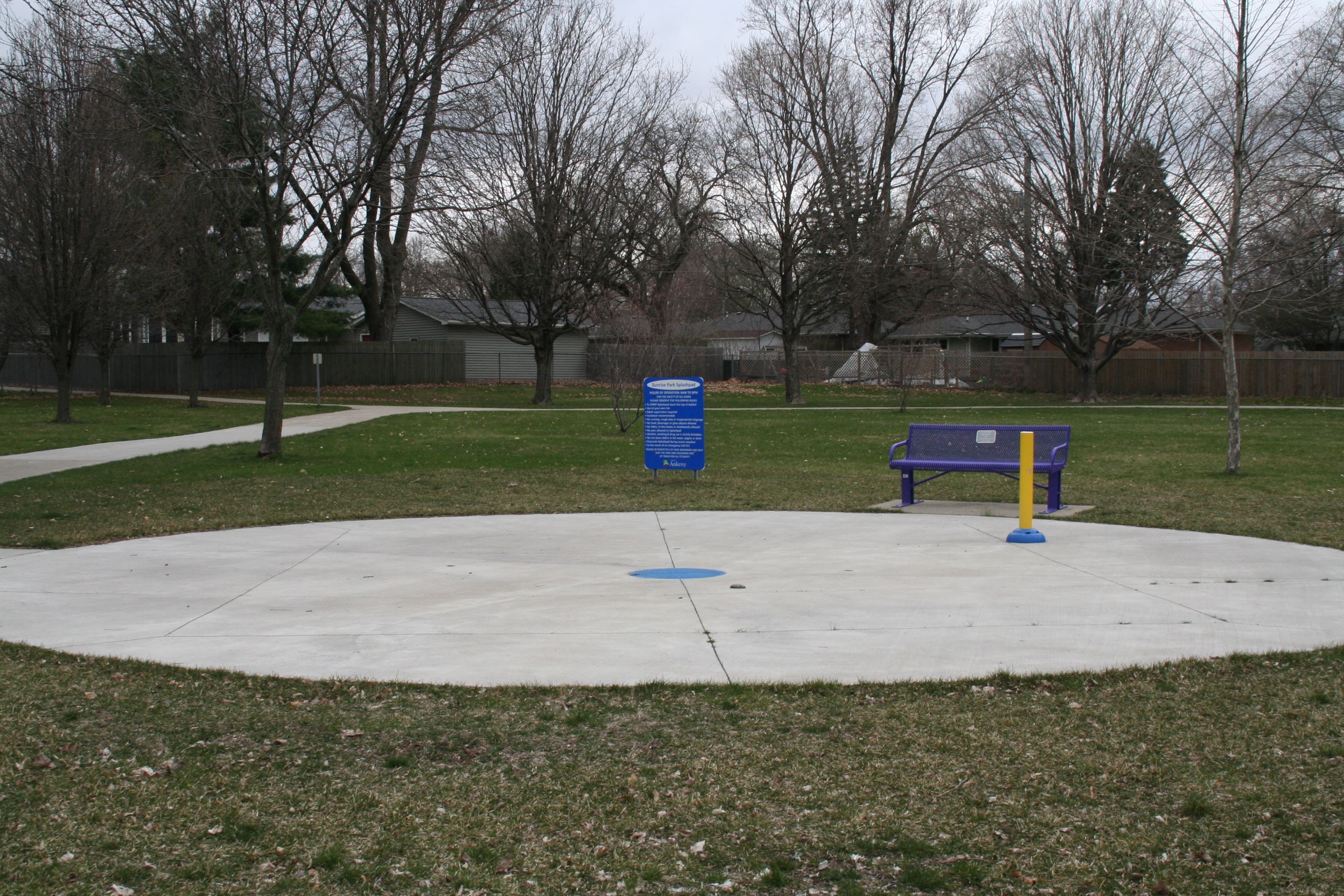 Kids running through spray features at an Ankeny splash pad.
