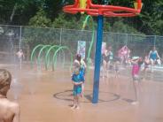 Children enjoying a mister feature at the Exeter spray pad.