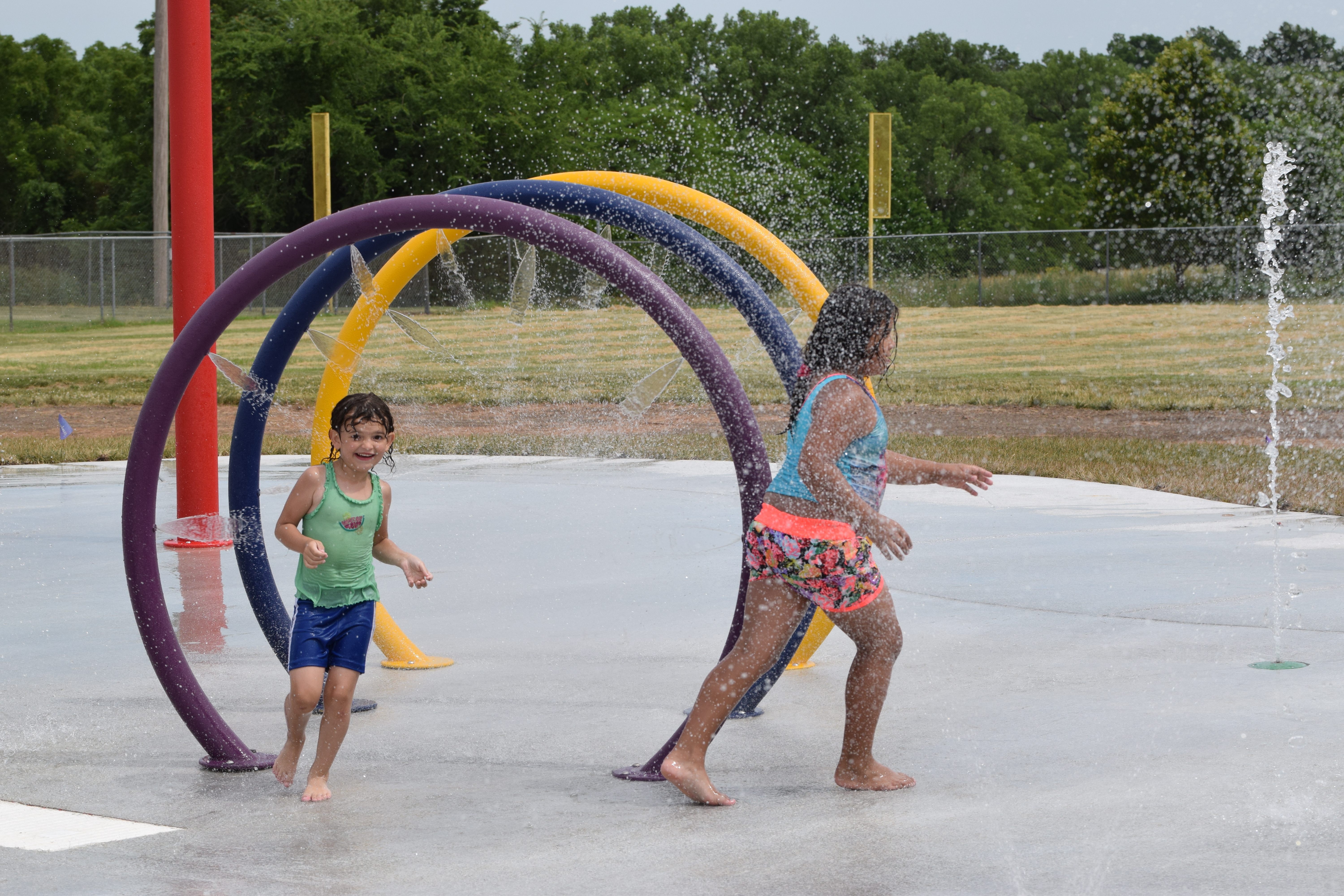 Children running through hoop sprays at Dornwood Spray Park.