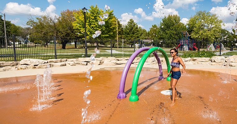 Young visitor cooling off at Douglass Spraygrounds.