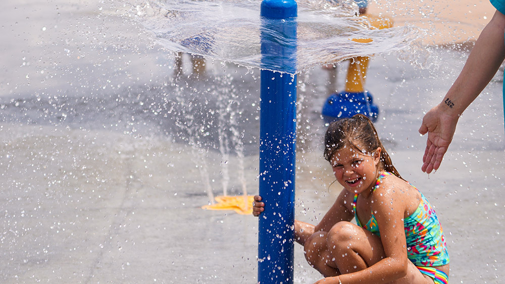 Kids using water features at Hayward Park Splash Pad.
