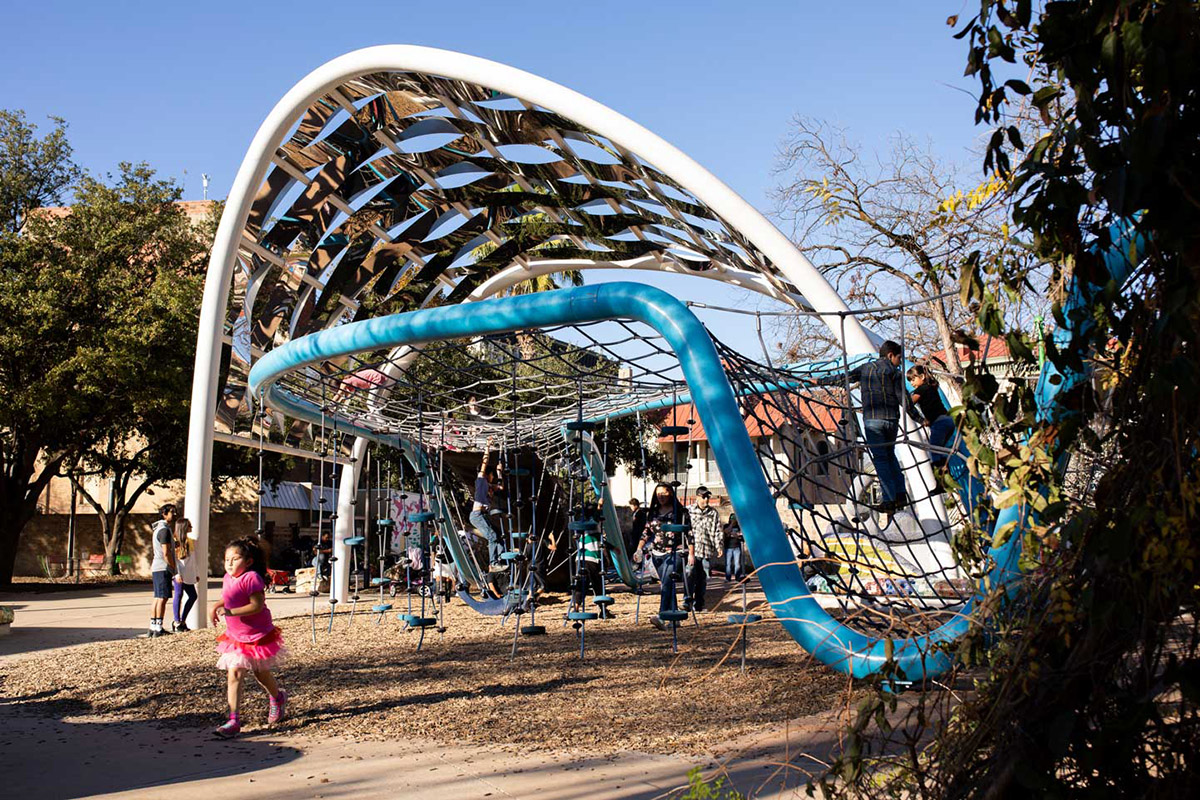 Child playing on a Hemisfair structure.