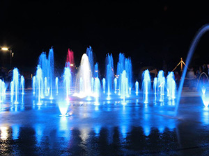 Imagination Fountain illuminated at night in Cascades Park.