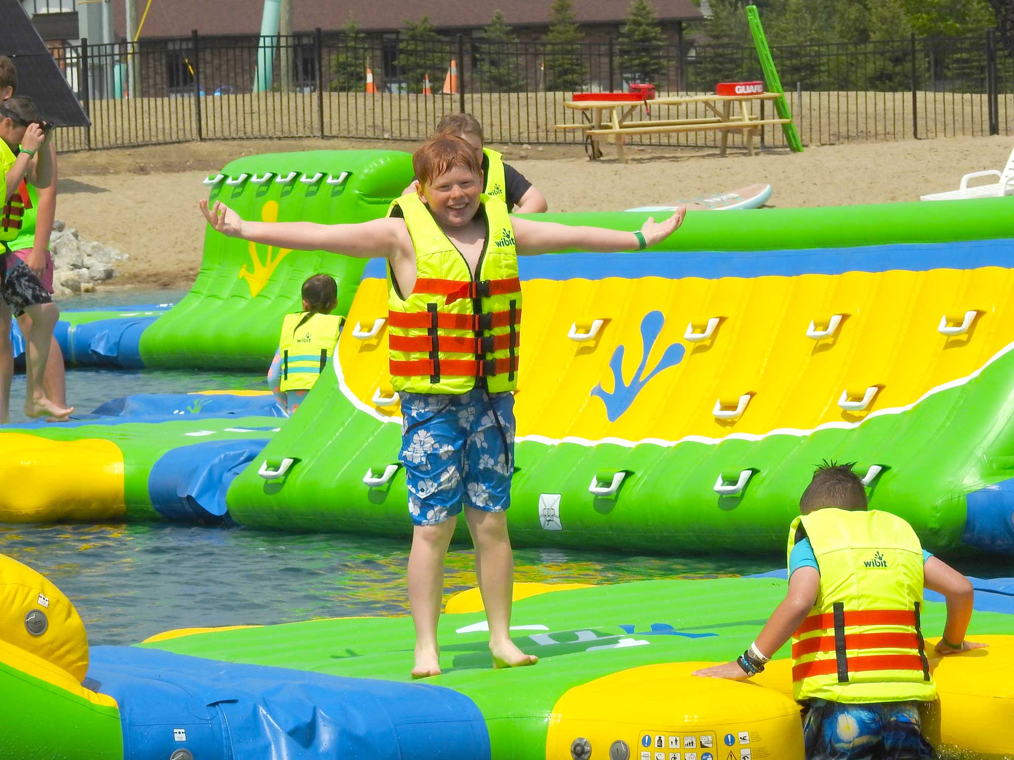 Child enjoying water play at Inukshuk Shores.