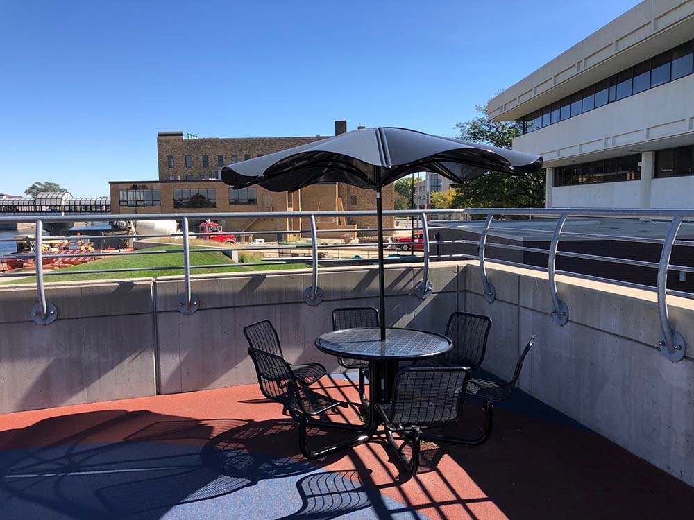 Table and chairs with umbrella shade at Mark's Park.