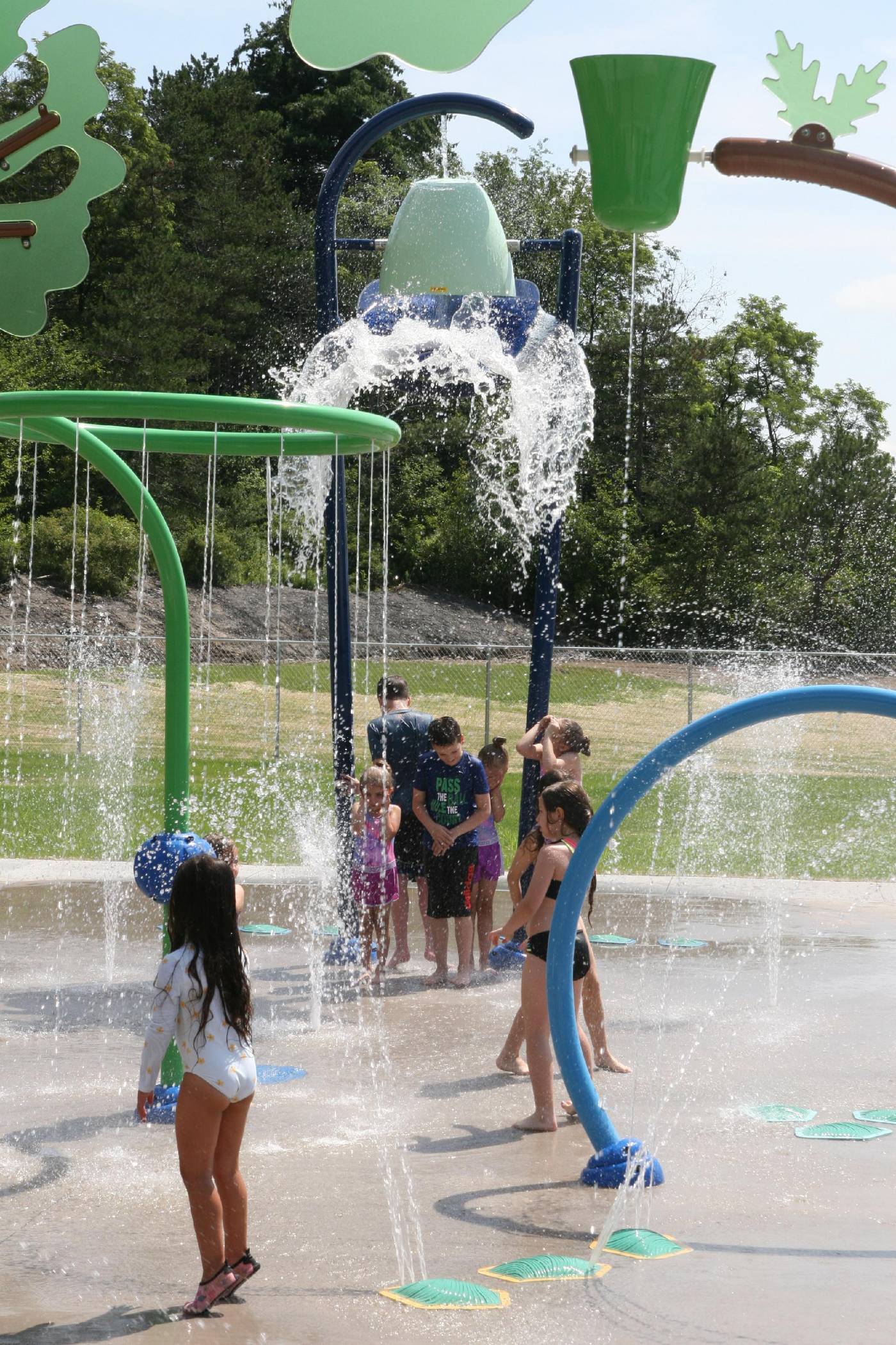 Wide view of water-play features at McDade Park splash pad.