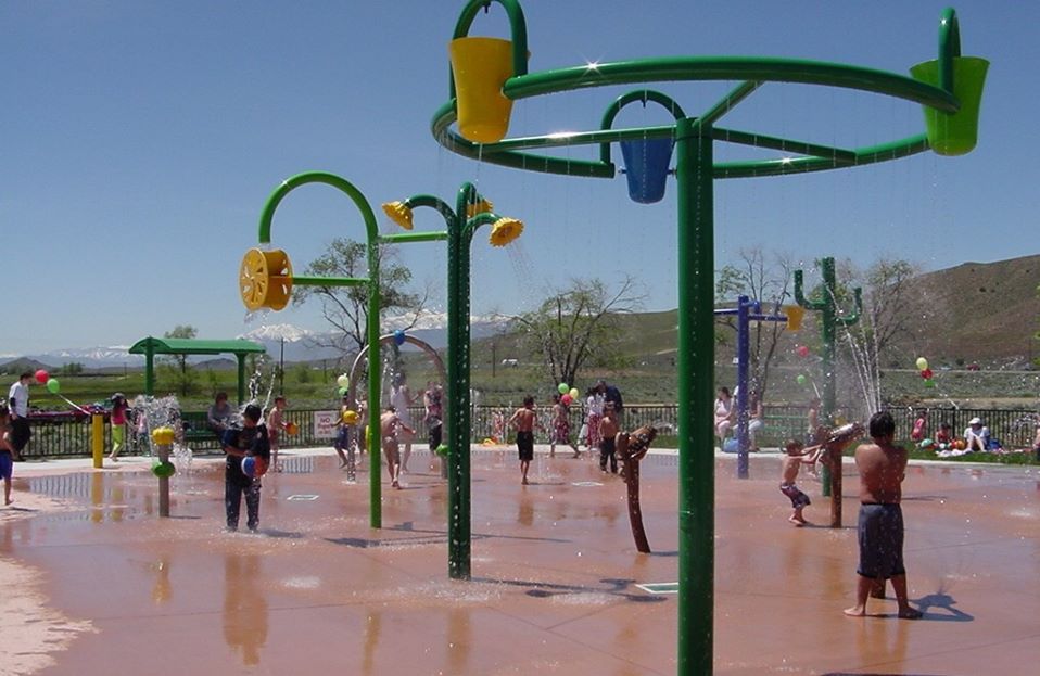Multiple sprayers and bucket features at Melio Gaspari Splash Park.