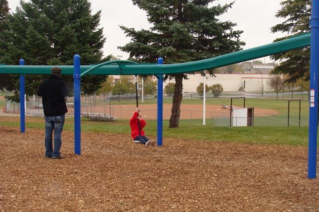 Family play scene at North Park in New Ulm.