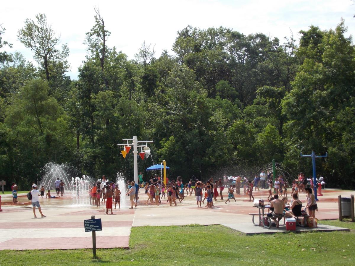 Families enjoying the splash area at Palmetto Island State Park.