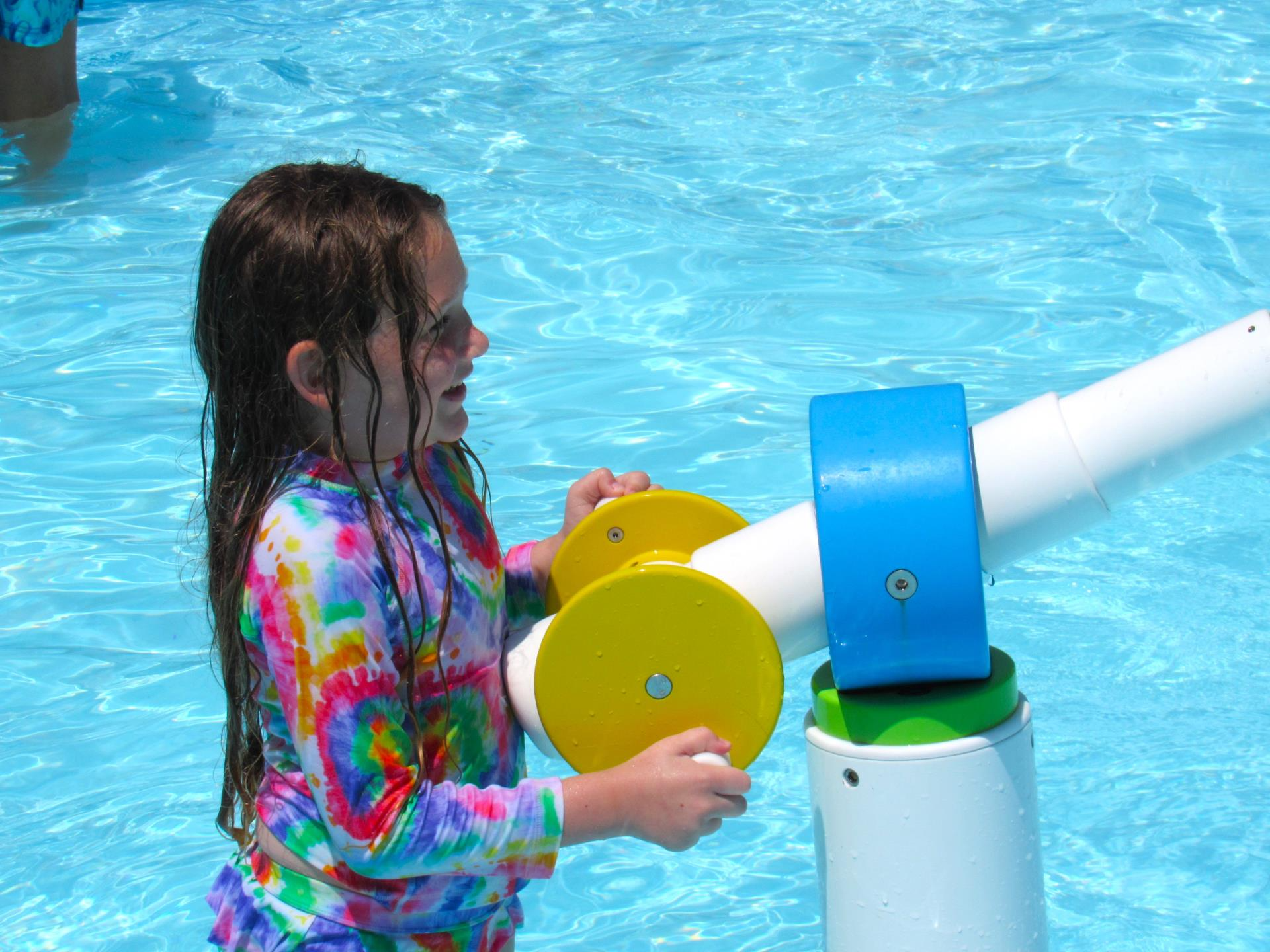 Child in the aquatic center recreational water area.