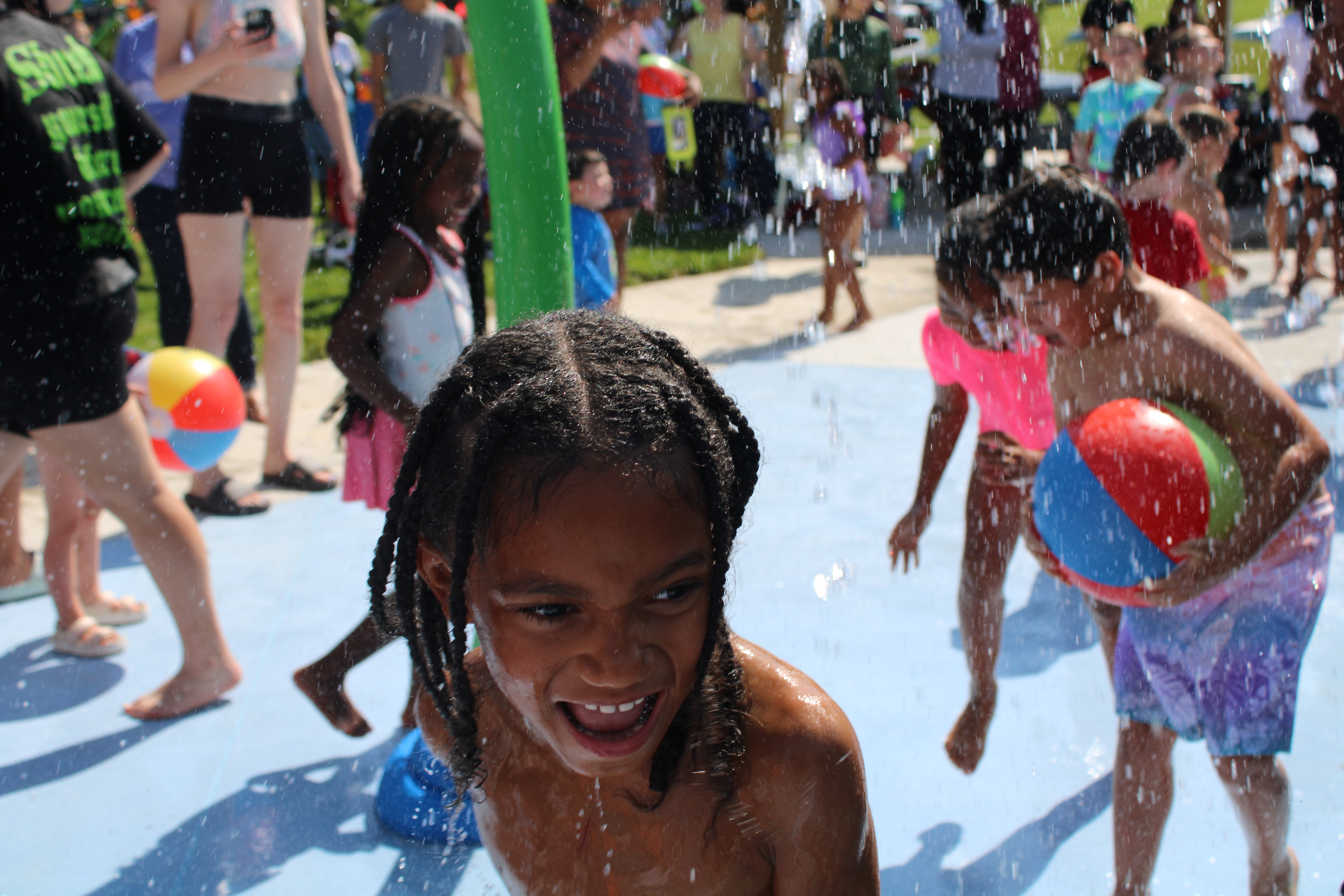 Children using water features at the Harrisonburg spraygrounds.