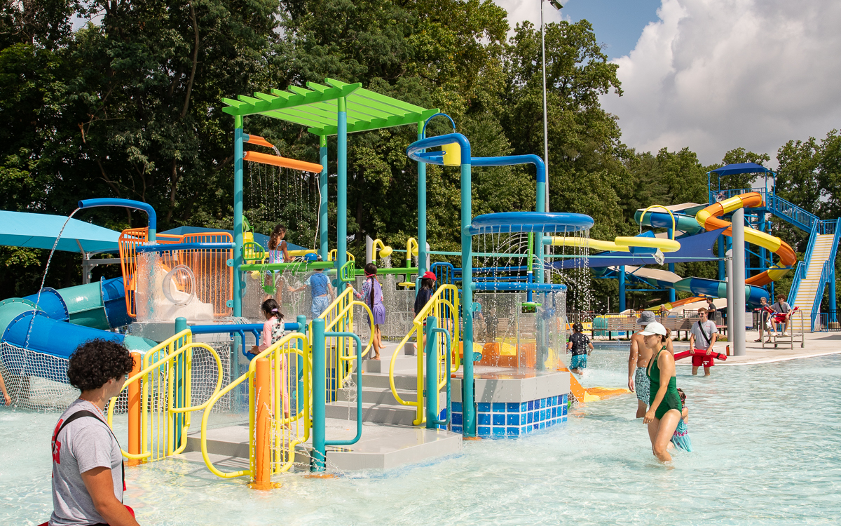 Outdoor recreation pool at Rockville Swim and Fitness Center with slides and shallow family play areas.