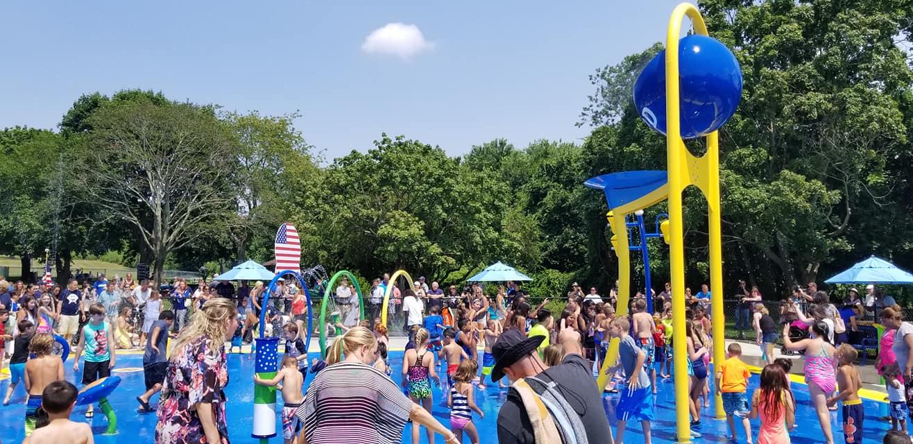 Families using the spray pad at Sgt. Paul Tuozzolo Memorial Spray Park.