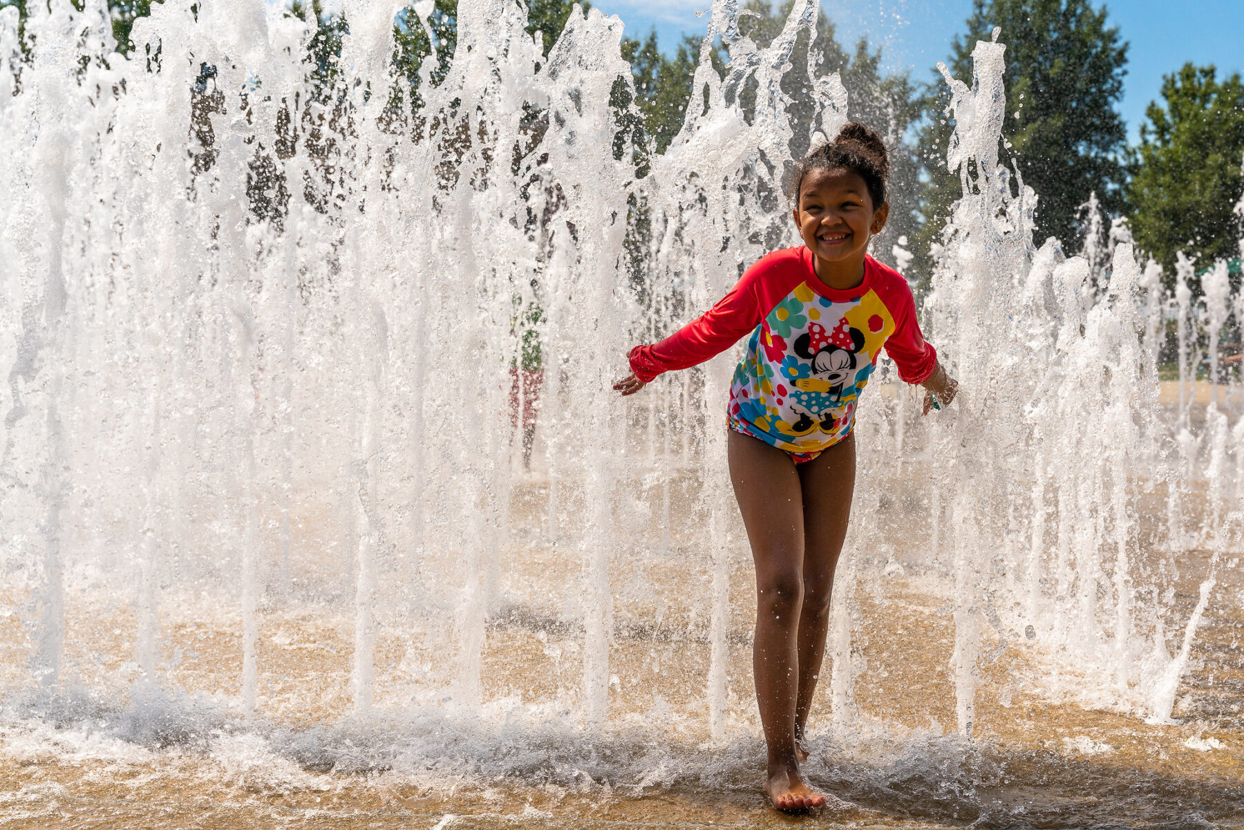 Child standing beside a water feature at South Germantown SplashPark.