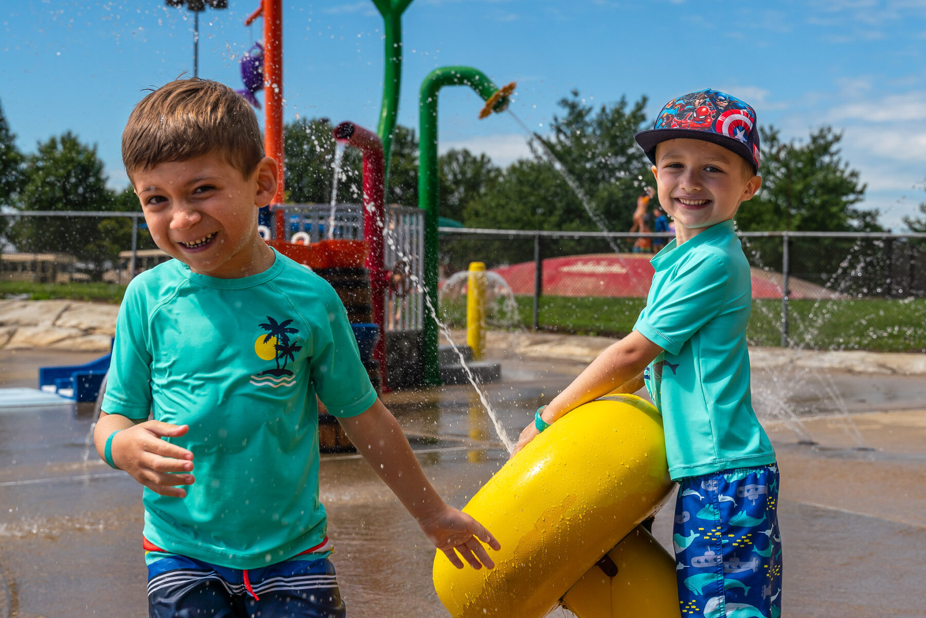 Two children playing with spray features at South Germantown SplashPark.