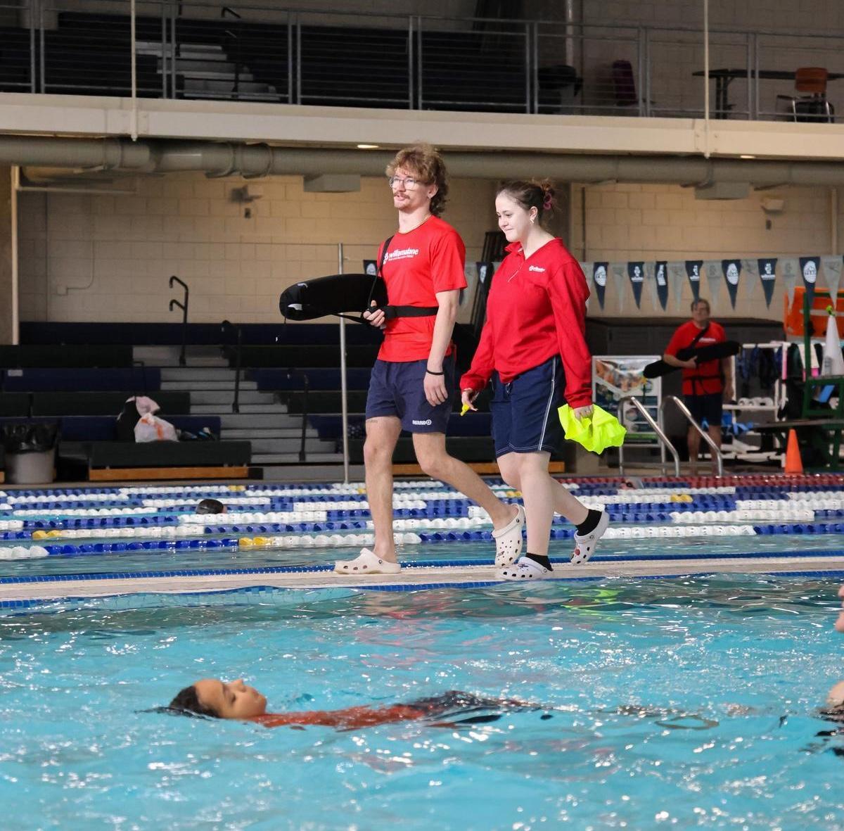 Lifeguards walking along the pool deck at Splash! at Lively Park.
