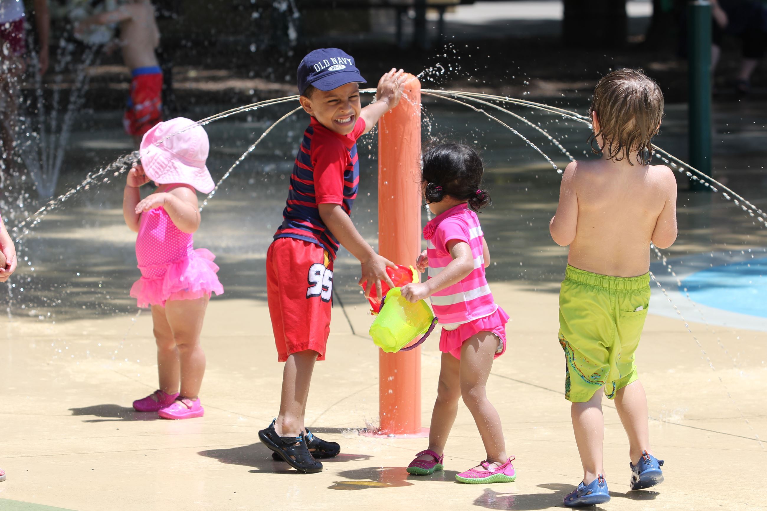 Children playing in the splash park at Manhattan City Park.