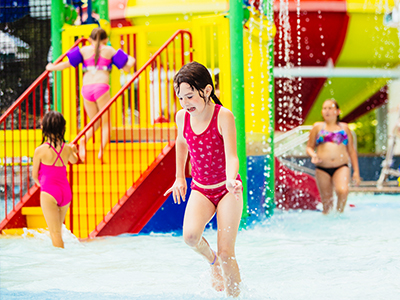 Child playing in the Splash Valley sprayground.