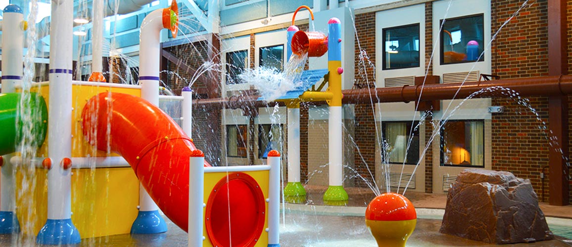 Different features at Splash Zone Waterpark including sprayers, slides and a dump bucket.