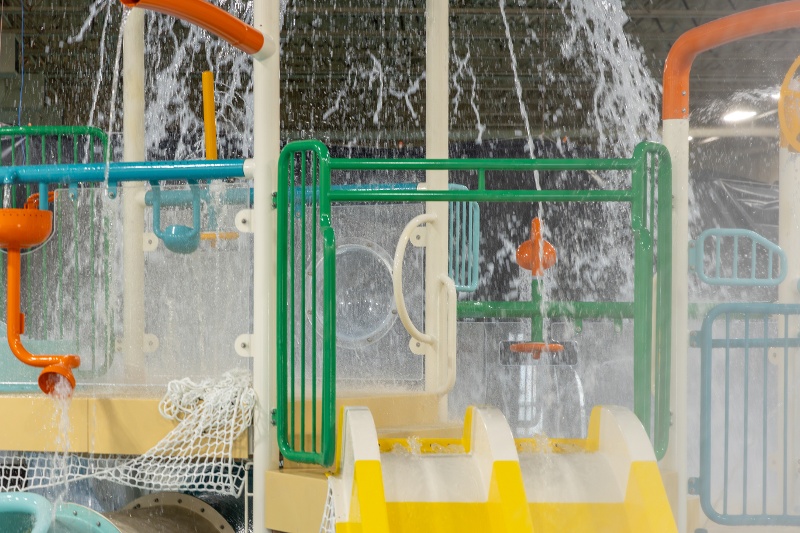 Indoor splash area at The Alaska Club South with interactive play features.
