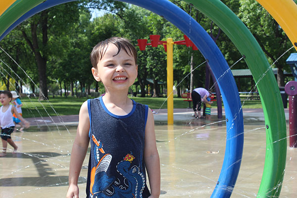 Wide view of University Park's splash area and surrounding park setting.
